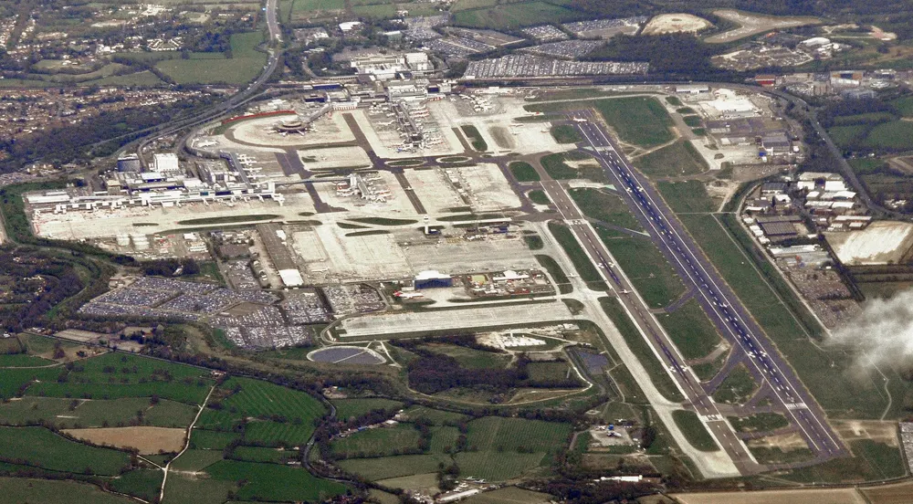 Aerial view of London Gatwick Airport with its single main runway, terminals and surrounding countryside