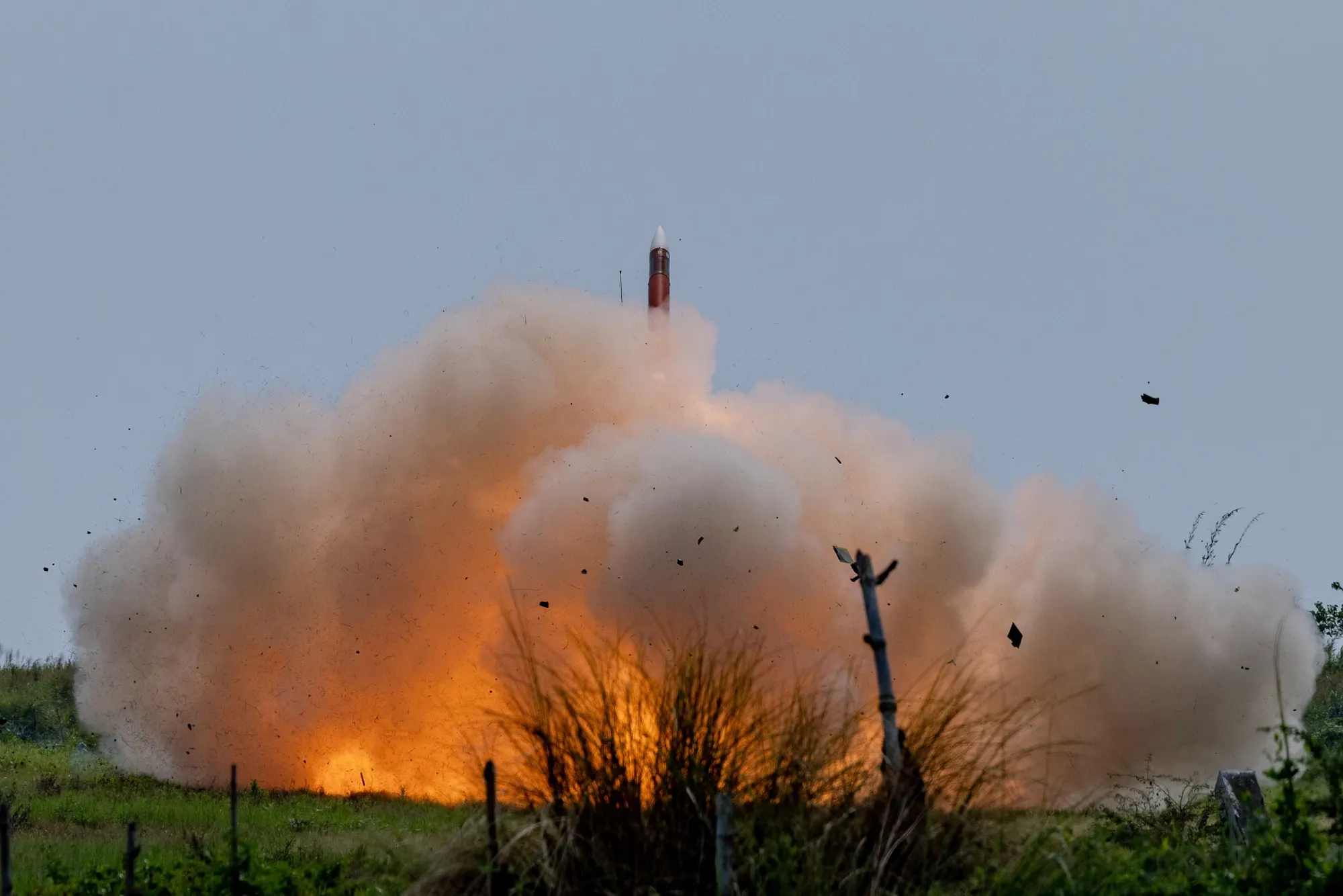 A U.S. Army Patriot missile leaving its launcher in a burst of orange flame and grey smoke during an exercise in the Philippines