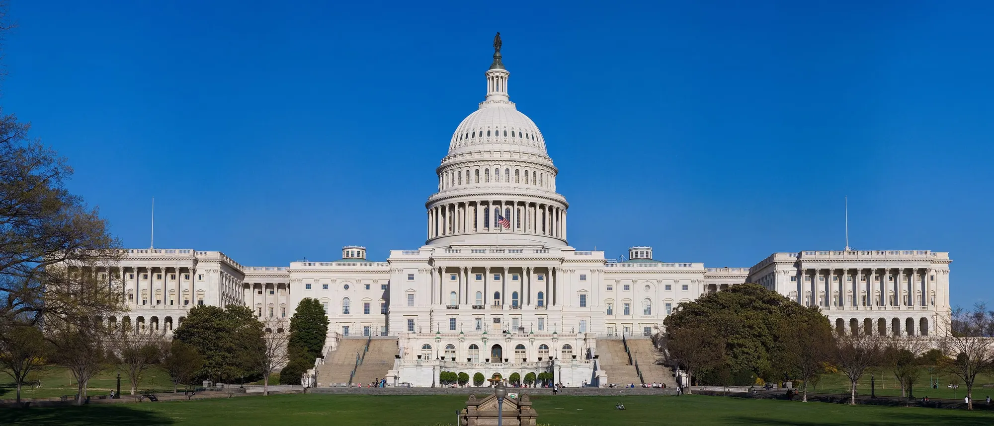 The west front of the United States Capitol in Washington, D.C., with its white dome under a clear blue sky