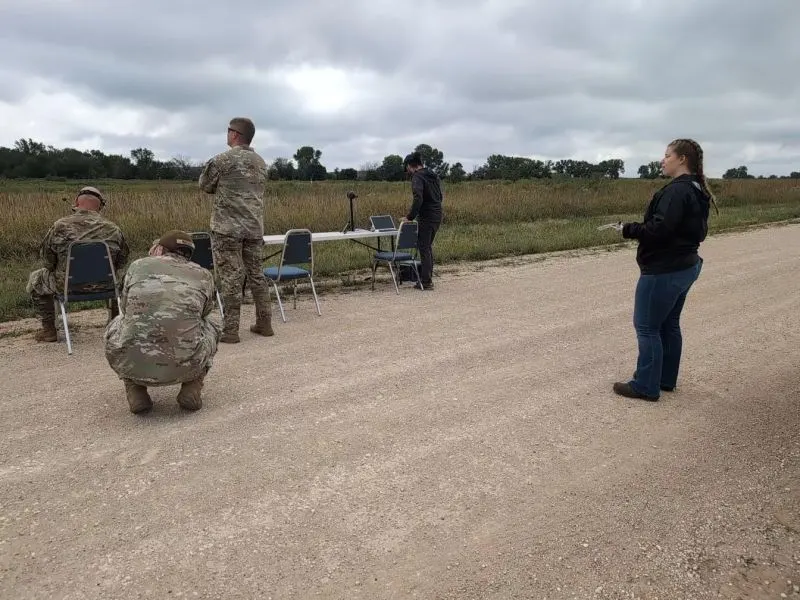 The DroSonic team and military observers at a roadside test position during DIRT Days 26.04, with a laptop and sensor on a folding table